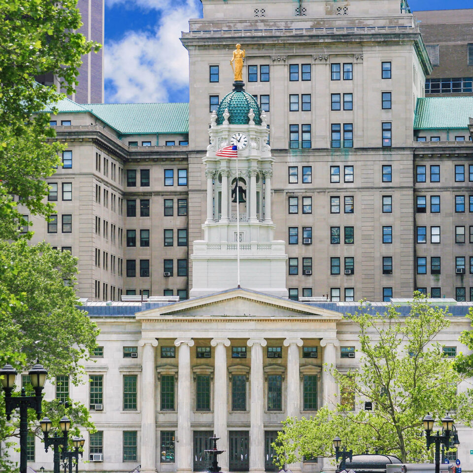 Historic Building that houses Brooklyn (Kings County) Borough Hall, Brooklyn, NY, USA. Green trees and vivid blue sky with clouds are in the image.