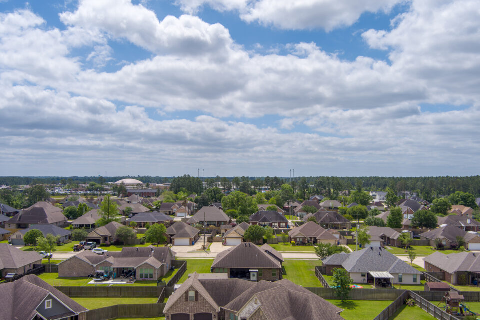 Aerial view of a neighborhood in Lumberton Texas with a overcast sky in late Springtime.